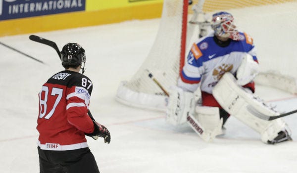 Canada’s Sidney Crosby, left, watches the puck in Russia’s goalkeeper Sergei Bobrovski's goal after his shot, during the Hockey World Championships gold medal match in Prague, Czech Republic, on Sunday.