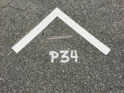 (Photo by Gene Martin/Special to The Gazette) These white chevrons have been cropping up on South New Hope Road this month. The state Department of Transportation reports they are used for aerial surveying work in regard to future road projects. The object in the middle is a 12-inch ruler placed there to get perspective of size.