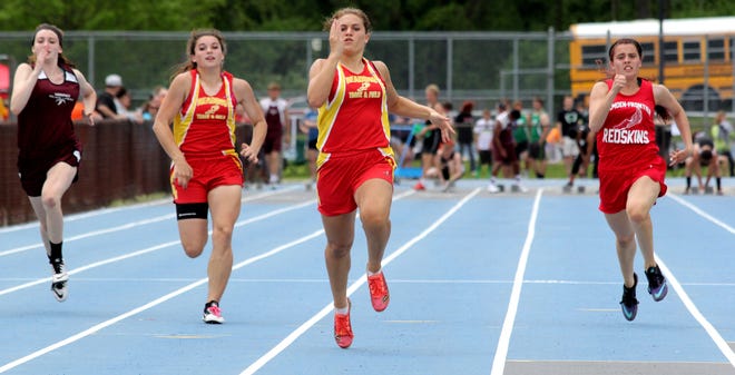 Reading's Jennifer Davis ran away with the 100-meter dash finals Saturday winning with a time of 12.59. Cheyenne Sliter of Camden (right) was second and Kaitlin Seager of Reading was third. ANDY BARRAND PHOTO