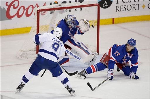 Tampa Bay Lightning center Tyler Johnson (9) shoots to score his second goal of the game against New York Rangers goalie Henrik Lundqvist (30) during the first period of Game 2 of the Eastern Conference final during the NHL hockey Stanley Cup playoffs, Monday, May 18, 2015, in New York.