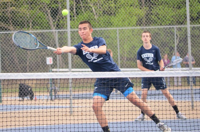 Exeter High School sophomore Tucker Guen, front, plays a ball at the net as No. 1 doubles partner Cam Maher looks on during Friday's Division I boys tennis match against Nashua North. The Blue Hawks improved to 9-2 in Division I with Friday's 8-1 win. Ryan O'Leary/Seacoastonline