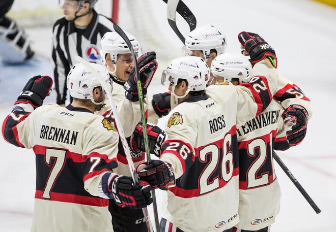 IceHogs left-winger Garret Ross (26) celebrates with his teammates after scoring the first of three goals in a Dec. 7 game against Lake Erie.

ERIK ANDERSON/RRSTAR.COM