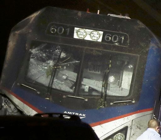 This May 12, 2015 photo shows a broken windshield of an Amtrak train after it derailed in Philadelphia. The FBI has been called in to investigate the possibility that the windshield of the train was hit with an object shortly before deadly train derailment. The revelation came at a National Transportation Safety Board briefing on Friday evening, raising new questions about the accident. (Elizabeth Robertson/The Philadelphia Inquirer via AP)