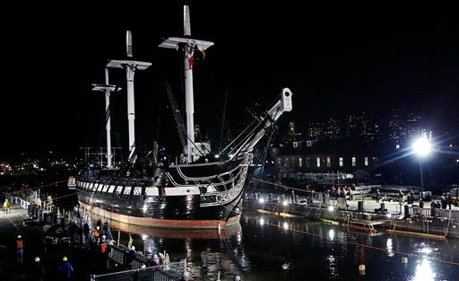 The USS Constitution is guided into a dry dock in Boston, Monday, May 18, 2015. The world's oldest commissioned warship still afloat, which was launched in 1797, will under go a major restoration project. The project is expected to take three years to complete and as much as $15 million to complete. (AP Photo/Charles Krupa)