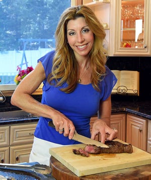 Chef Shereen Pavlides slices the steak before serving.