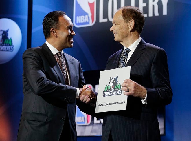 NBA Deputy Commissioner Mark Tatum, left, congratulates Minnesota Timberwolves owner Glen Taylor after the Timberwolves won the first pick in the draft, during the NBA basekball draft lottery, Tuesday, May 19, 2015, in New York.