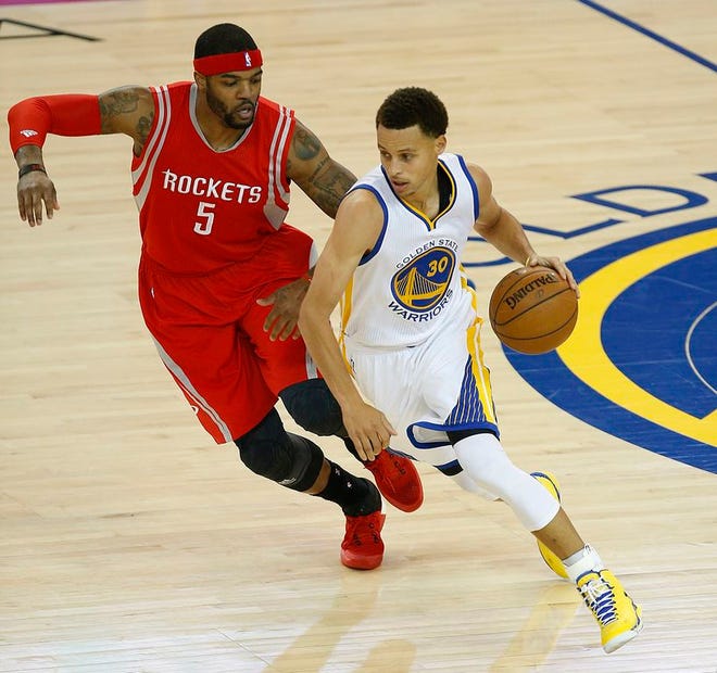 Golden State Warriors guard Stephen Curry (30) dribbles against Houston Rockets forward Josh Smith (5) during the first half of Game 1 of the NBA basketball Western Conference finals in Oakland, Calif., Tuesday, May 19, 2015.