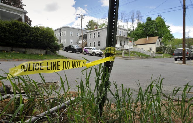 Police crime tape marks the site of a fatal shooting May 12 at Milk and Otis streets in Fitchburg. T&G Staff File Photo/Paul Kapteyn
