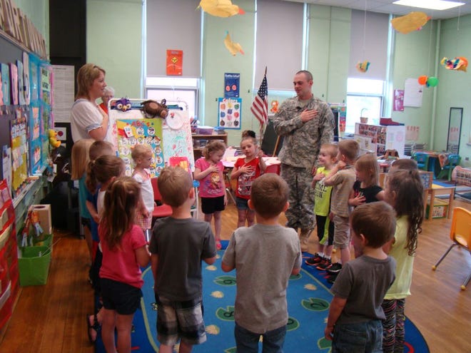 Spc. Justin Moulton doing the Pledge of Allegiance along with Northside Preschool students.