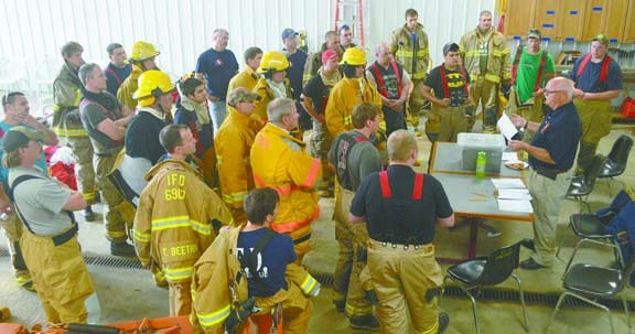 Edward Sayre, regional training coordinator and Mancelona fIre chief, gives final instructions to firefighting cadets preparing to test their skills as 12 stations as part of Firefighter 1 and Firefighter 2 classes Saturday at the Cheboygan County Fairgrounds. Approximately 31 completed the class and passed the practical portion of the training. Results are pending for the written test.