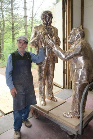 Dexter Benedict with the figures of Edison and Steinmetz before he applied the patina.