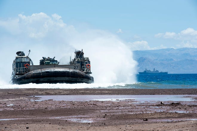 Landing Craft Air Cushion (LCAC) 27, assigned to Assault Craft Unit (ACU) 4, conducts the offloading of the 24th Marine Expeditionary Unit (MEU) from the amphibious transport dock ship USS New York (LPD 21). New York is deployed in support of maritime security operations and theater security cooperation efforts in the U.S. 5th Fleet AOR.