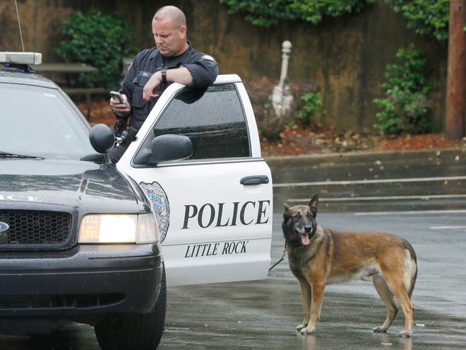 A Little Rock police officer and dog assist the Drug Enforcement Administration outside a medical clinic in Little Rock, Ark., Wednesday. The DEA began wrapping up a multistate crackdown on prescription drug abuse with raids at pain clinics, pharmacies and other locations in the South.