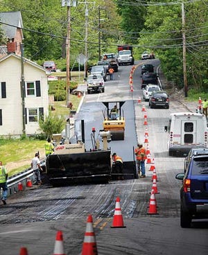 Photo by Tracy Klimek/New Jersey Herald - Route 94 is shut down to one lane in Blairstown as vehicles pass a construction crew laying blacktop on Wednesday.