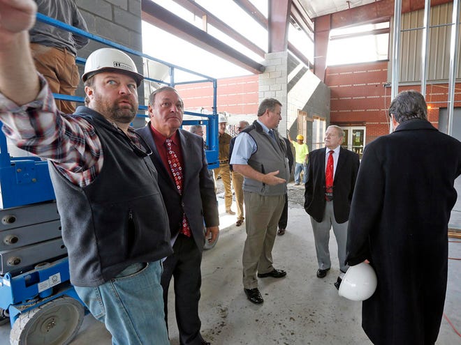Jim Davis, program manager with Harrison Construction, left, talks with Tuscaloosa County Commissioner Jerry Tingle as Gary Minor, executive director of Tuscaloosa Park and Recreation Authority, talks with Tuscaloosa County Commissioner Bobby Miller and Keith Scott, of Ward Scott Architecture, about the addition to the Bobby Miller Center in Tuscaloosa Wednesday, Dec. 17, 2014.