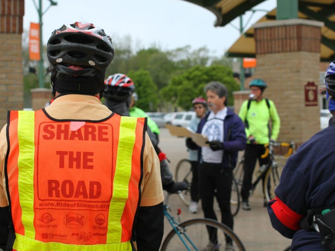 Cyclists listen to instruction about the ride from organizer Mark Hagar. Rob Wetterholt Jr./Sentinel Staff