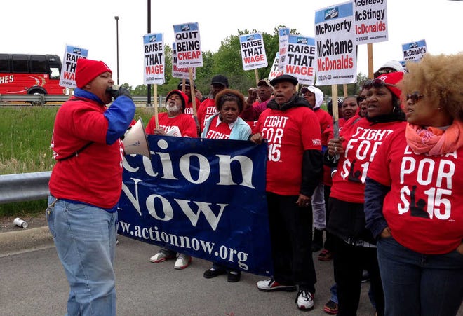 Ellyson Carter, left, chants along with protesters calling for pay of $15 an hour and a union march near McDonald's headquarters in Oak Brook, Ill., Wednesday, May 20, 2015. The start of the two-day demonstration comes ahead of the company's annual shareholder meeting on Thursday. (Bev Horne/Daily Herald via AP) MANDATORY CREDIT; MAGS OUT