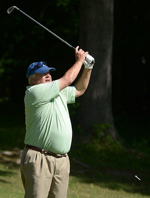 Ernie York, who competed in the championship flight, finishes a tee shot on the fourth hole during the Alamance County Senior Amateur.