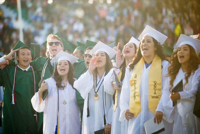 Victor Valley High School graduates sing their alma mater during the Class of 2015 Graduation at Ray Moore Stadium, Thursday evening in Victorville. (Jose Huerta, Daily Press)
