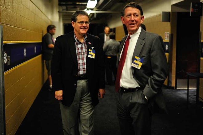 University of Georgia President Jere Morehead and athletic director Greg Mcgarity smile in a hallway after an SEC tournament quarterfinal game between Georgia and South Carolina on Friday, March 13, 2015, in Nashville, Tenn. (AJ Reynolds/Staff, @ajreynoldsphoto)