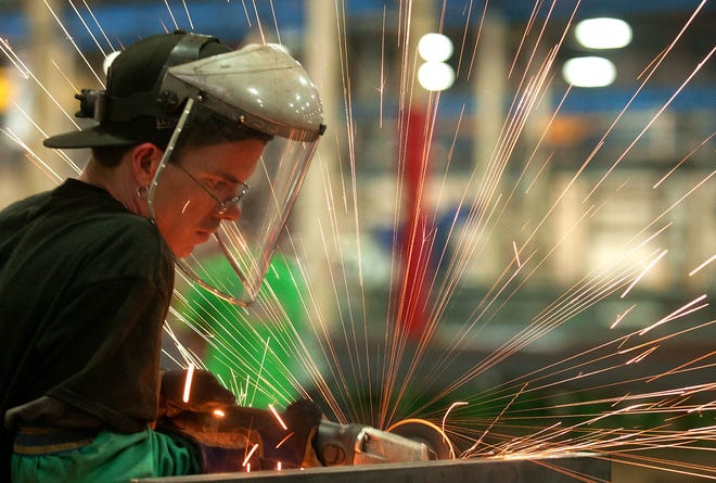 Sparks fly as Jeff McKay, a welder at PennFab, touches up welds at the plant in Falls Township on Tuesday May 19, 2015. McKay was one of a team of employees who worked round the clock to fabricate a structure to get the Amtrak Northeast Corridor line up and running again after the derailment last week.