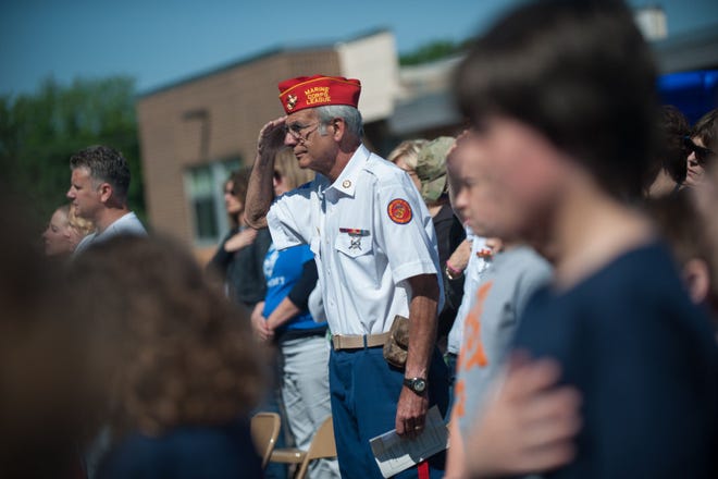 Peter Palestina, with the Marine Corps League of Pennsylvania's Patriot Detachment, salutes during the singing of the national anthem at the dedication ceremony for the new playground at Holland Elementary School in Southampton on Friday morning, May 22, 2015. During the festivities, Palestina was adopted as a veteran by the school.