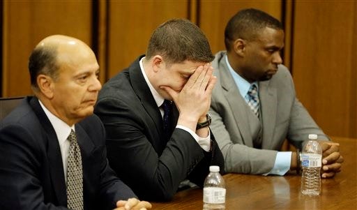 Cleveland police officer Michael Brelo, left, and one of his attorneys Fernando Mack, right, listen during closing arguments in Brelo's voluntary manslaughter trial, Tuesday, May 5, 2015, in Cleveland. Brelo is charged in the deaths of two people in a 137-shot barrage of police gunfire. (Marvin Fong /The Plain Dealer via AP)