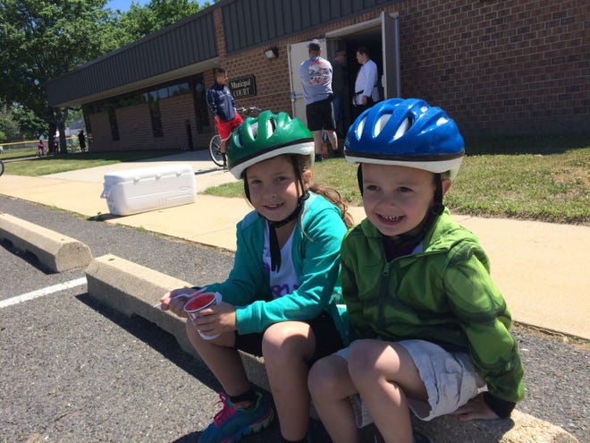 Samantha Moyer, 8, and Dylan Moyer, 4, of Roebling, take a break Saturday, May 23, 2015, from bike safety lessons during Florence's Community Bike Rodeo and Wellness Day.