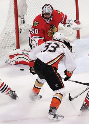 Chicago 
Blackhawks goalie Corey Crawford (50) makes a save in front of Anaheim Ducks right wing Jakob Silfverberg (33) during the second period in Game 3 of the Western Conference finals of the NHL hockey Stanley Cup playoffs, Thursday in Chicago.