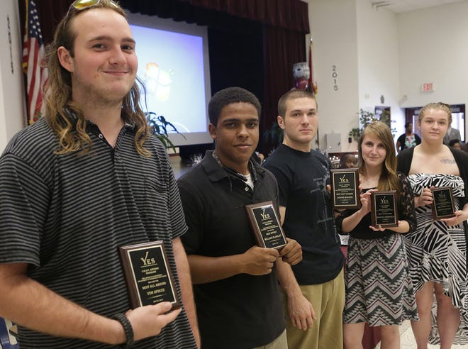 Students William Blakely, Austin Boozer, Rebecca Warfield and Ashley Kearns hold their CROP awards during a local senior recognition luncheon.