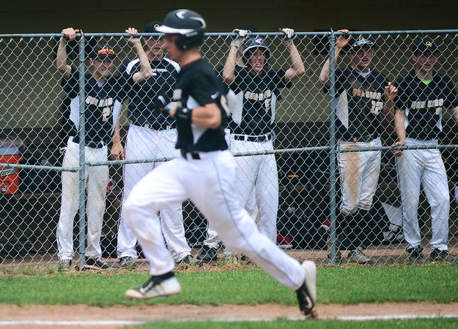 Quaker Valley players watch their teammate, starting pitcher Tyler Garbee, score against Riverside in the second inning during Monday's playoff game at Chippewa Park.