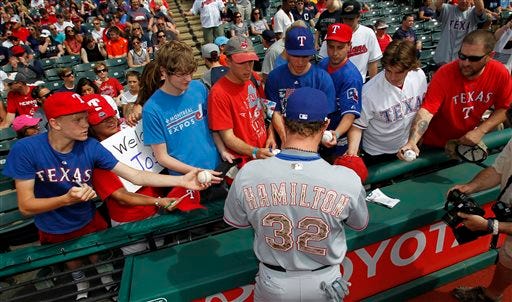 Texas Rangers' Josh Hamilton signs autographs for fans prior to the Rangers baseball game against the Cleveland Indians Monday, May 25, 2015, in Cleveland. (AP Photo/Aaron Josefczyk)