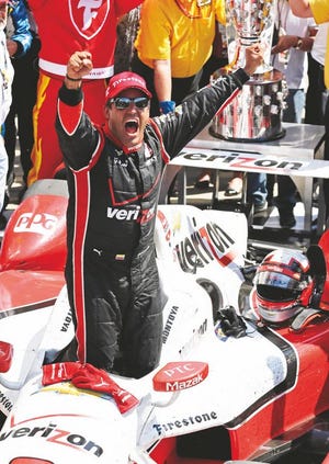 Juan Pablo Montoya, of Colombia, celebrates after winning the 99th running of the Indianapolis 500 auto race at Indianapolis Motor Speedway in Indianapolis, Sunday.