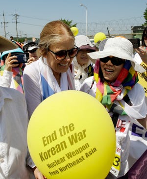U.S. activist Gloria Steinem, left, is greeted by South Korean activists 
after they crossed the Unification bridge by bus near the border village of 
Panmunjomon Sunday.
AP PHOTO / 
LEE JIN-MAN