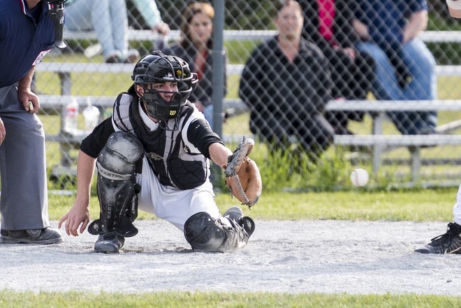 Westport catcher Sean Cusick reaches for the low and outside pitch during the Wildcats' game against Diman Voke. PHOTOS BY RYAN FEENEY/CHRONICLE