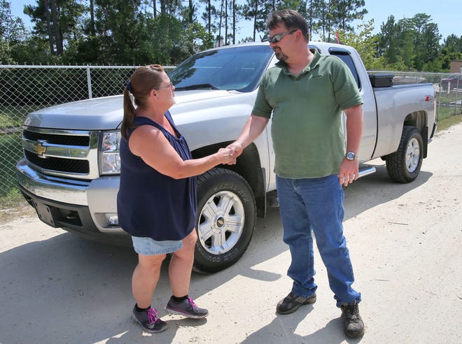 Julie Pardue shakes hands with Jerry Matthews after meeting him in person for the first time Thursday. Pardue helped Matthews recover his stolen Chevy Silverado.