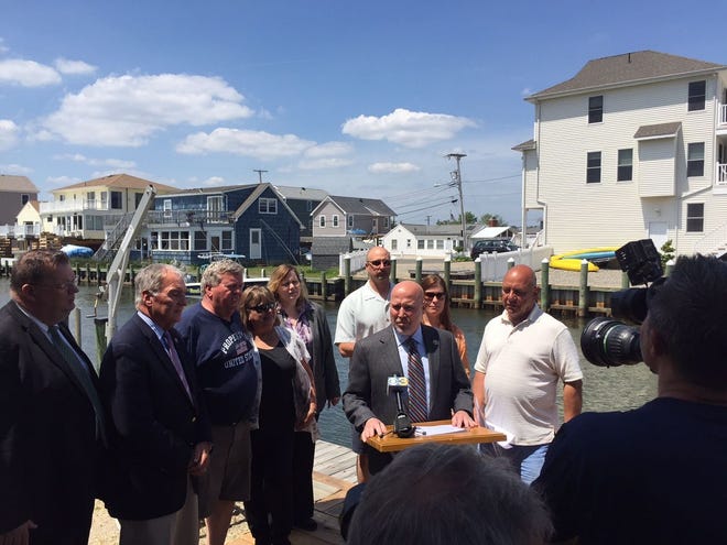 Rep. Tom MacArthur, R-3rd of Toms River, (center) speaks during a news conference announcing introduction of Disaster Survivor Benefit Clarification Act, which would permit disaster victims who received government loans to also receive aid grants.
