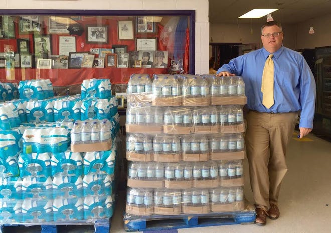 Marshwood Middle School Principal John Caverly stands next to pallets of bottled water donated from area stores, as the school continues E. coli testing on its water. Earlier this month the water was deemed unsafe to drink due to higher levels of E. coli found in several water samples. 

Photo by Jesse Scardina/Seacoastonline