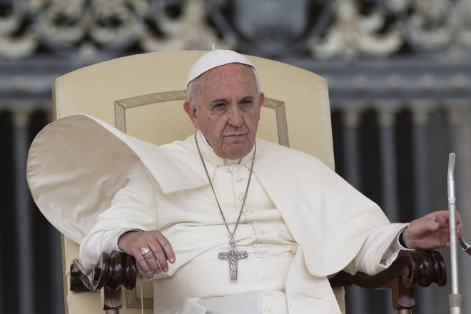 A gust of wind blows Pope Francis' mantle as he attends his weekly audience, at the Vatican Wednesday. AP PHOTO