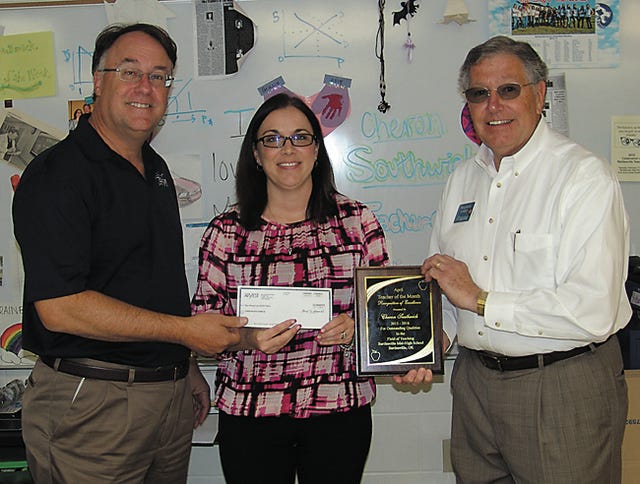 David Oakley, Jr., left, and Stephen Colaw, right, present Cheron Southwick with a check and plaque as recognition of being named Bartlesville Teacher of the Month for April.