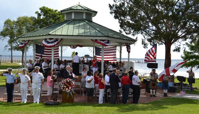 Military, Clay County and Green Cove Springs officials render honors during the singing of the national anthem during the kick-off of the 27th annual Memorial Day Riverfest on May 25.