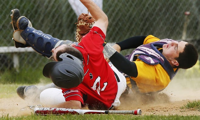 Old Rochester's Austin Salkind and Case catcher Mike Lafleur collided at home plate on this play in the bottom of the second inning on Wednesday. Salkind was called out. MIKE VALERI/THE STANDARD-TIMES