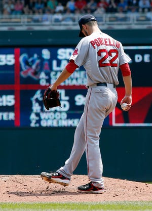 Red Sox starter Rick Porcello sweeps the mound with his foot Wednesday after giving up a walk in the third inning of Boston's 6-4 loss to the Twins. THE ASSOCIATED PRESS