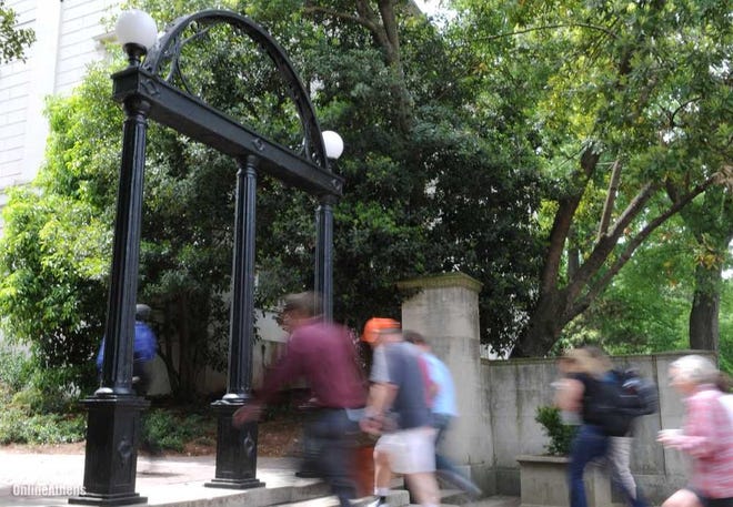 People walk through and around The University of Georgia Arch on North Campus in Athens Monday, April 19, 2010. (Kelly Wegel/photo@onlineathens.com)