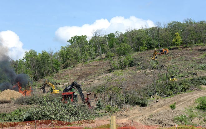 Construction vehicle clear a hillside along Route 18 as preparation of the Shell site continues on Wednesday in Potter Township.