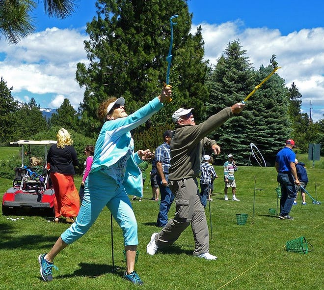 Cheryl and Jerry 'whing' golf balls down the driving range during the May 23 Whing golf introduction at Mount Shasta Resort. “It's different,” Jerry said. “I can throw it straighter than golf.”