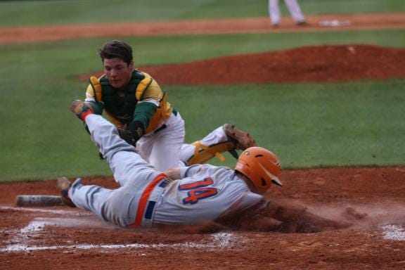 Crest catcher Bradley Keller tags out Marvin Ridge's Jake Boyce at home Thursday night at Crest in Game 2 of the 3A West regional final. The Chargers' season came to an end with a 5-4 loss.