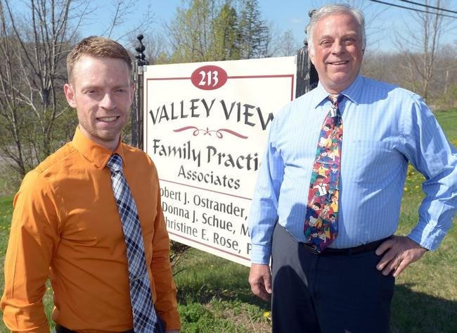Valley View Family Practice co-founder Dr. Robert Ostrander, right, welcomes his son Dr. Geoffrey Ostrander to the Rushville practice.