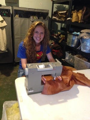 Katy Biser working on a costume for the upcoming production, 'Liberty Mountain.'