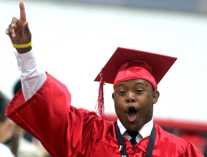 James Mickles Jr. cheers as he and other 2015 graduates enter the gym for the ceremony at North Shelby on Friday. (Brittany Randolph/The Star)